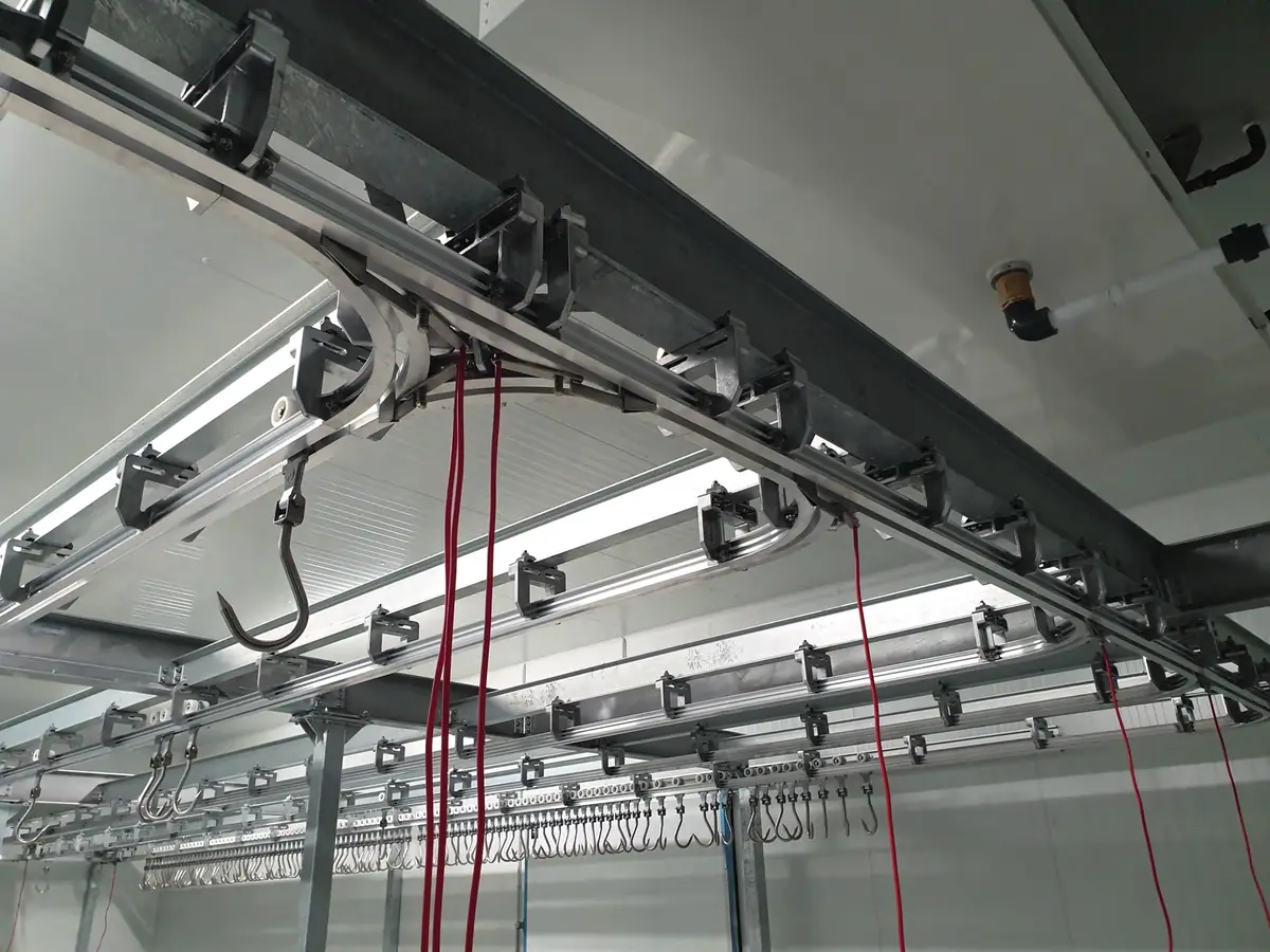 Overhead rail switch with trolleys and hooks
